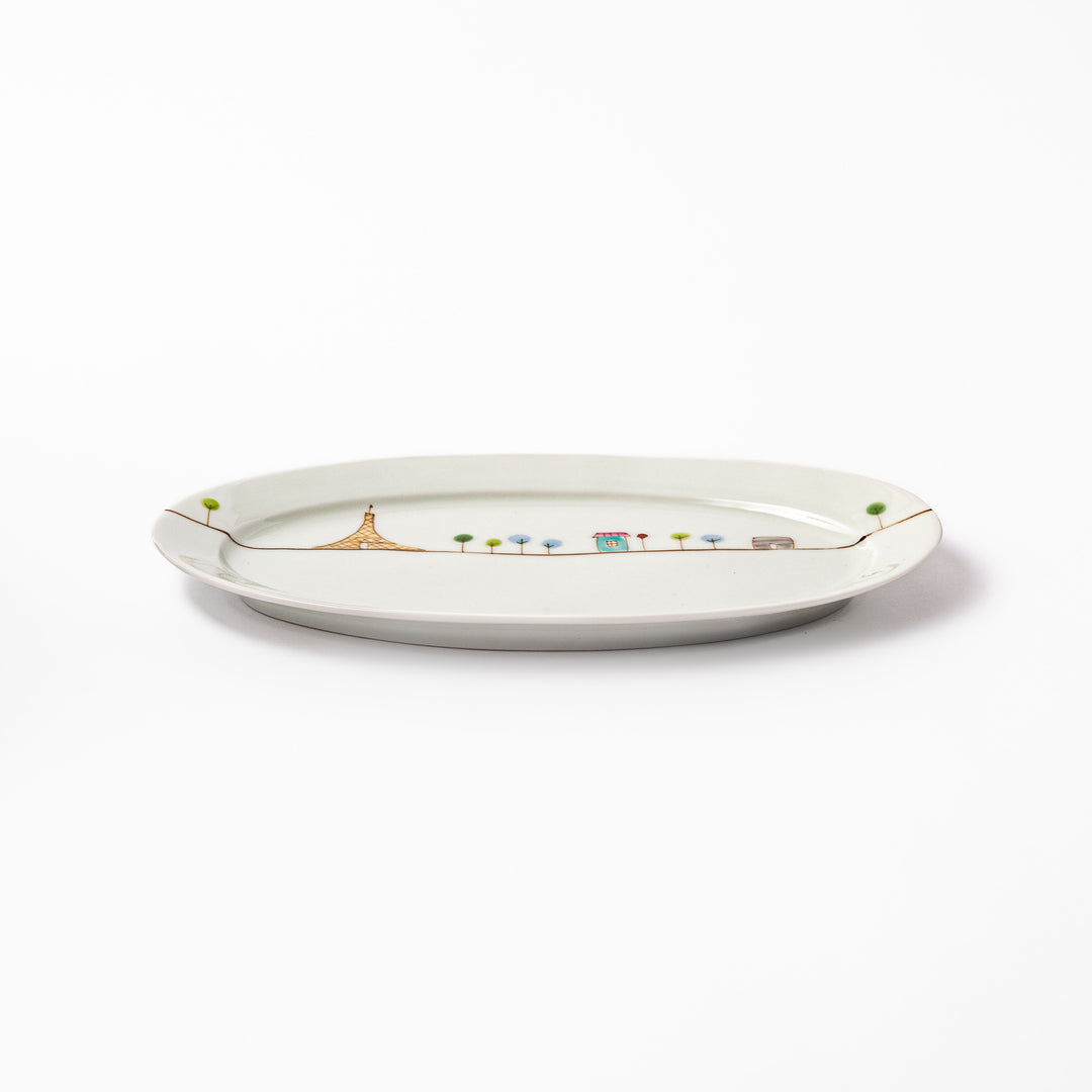 Japanese porcelain oval plate with whimsical France design featuring Eiffel Tower, Arc de Triomphe, trees, and colorful house