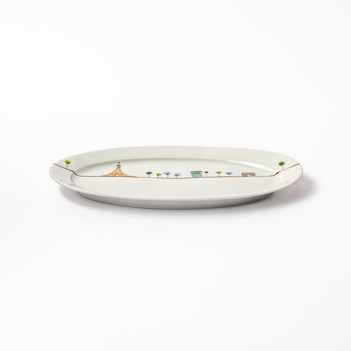 Japanese porcelain oval plate with whimsical France design featuring Eiffel Tower, Arc de Triomphe, trees, and colorful house