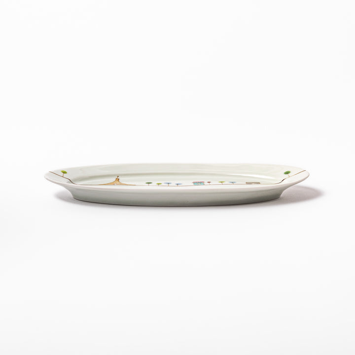 Japanese porcelain oval plate with whimsical France design featuring Eiffel Tower, Arc de Triomphe, trees, and colorful house
