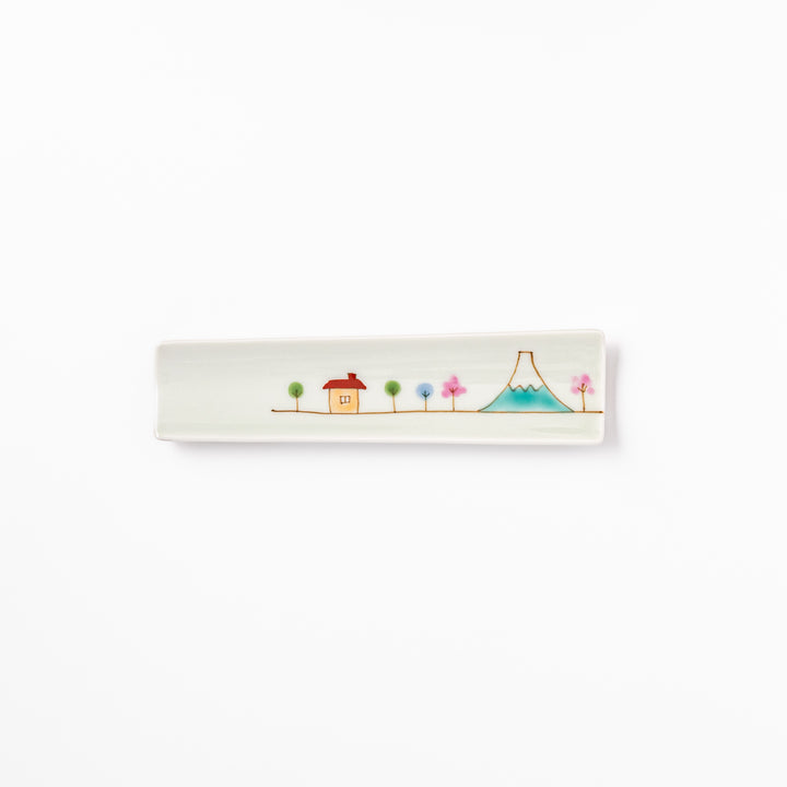Japanese porcelain chopstick rest with whimsical Japan design featuring Mount Fuji, cherry blossoms, house, and colorful trees