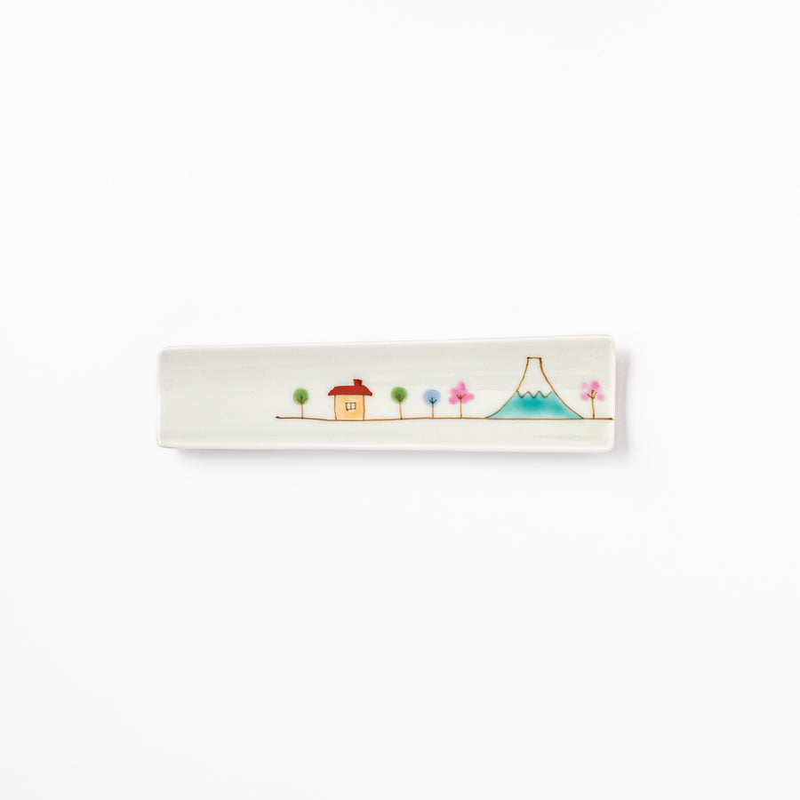Japanese porcelain chopstick rest with whimsical Japan design featuring Mount Fuji, cherry blossoms, house, and colorful trees