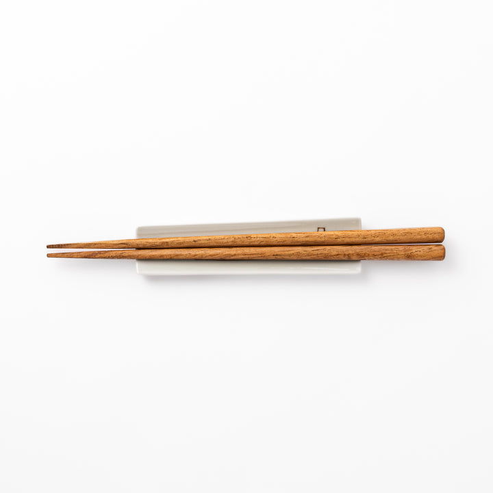 Japanese porcelain chopstick rest with whimsical Japan design featuring Mount Fuji, cherry blossoms, house, and colorful trees