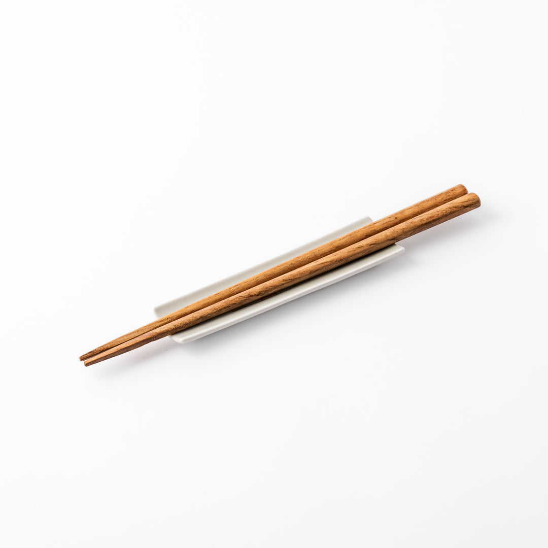 Japanese porcelain chopstick rest with whimsical Japan design featuring Mount Fuji, cherry blossoms, house, and colorful trees
