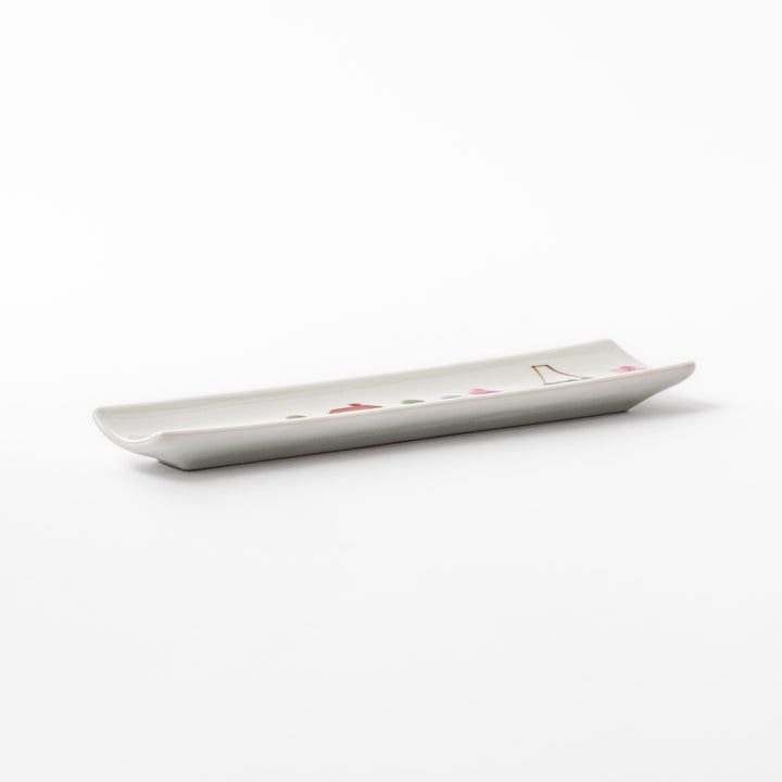 Japanese porcelain chopstick rest with whimsical Japan design featuring Mount Fuji, cherry blossoms, house, and colorful trees