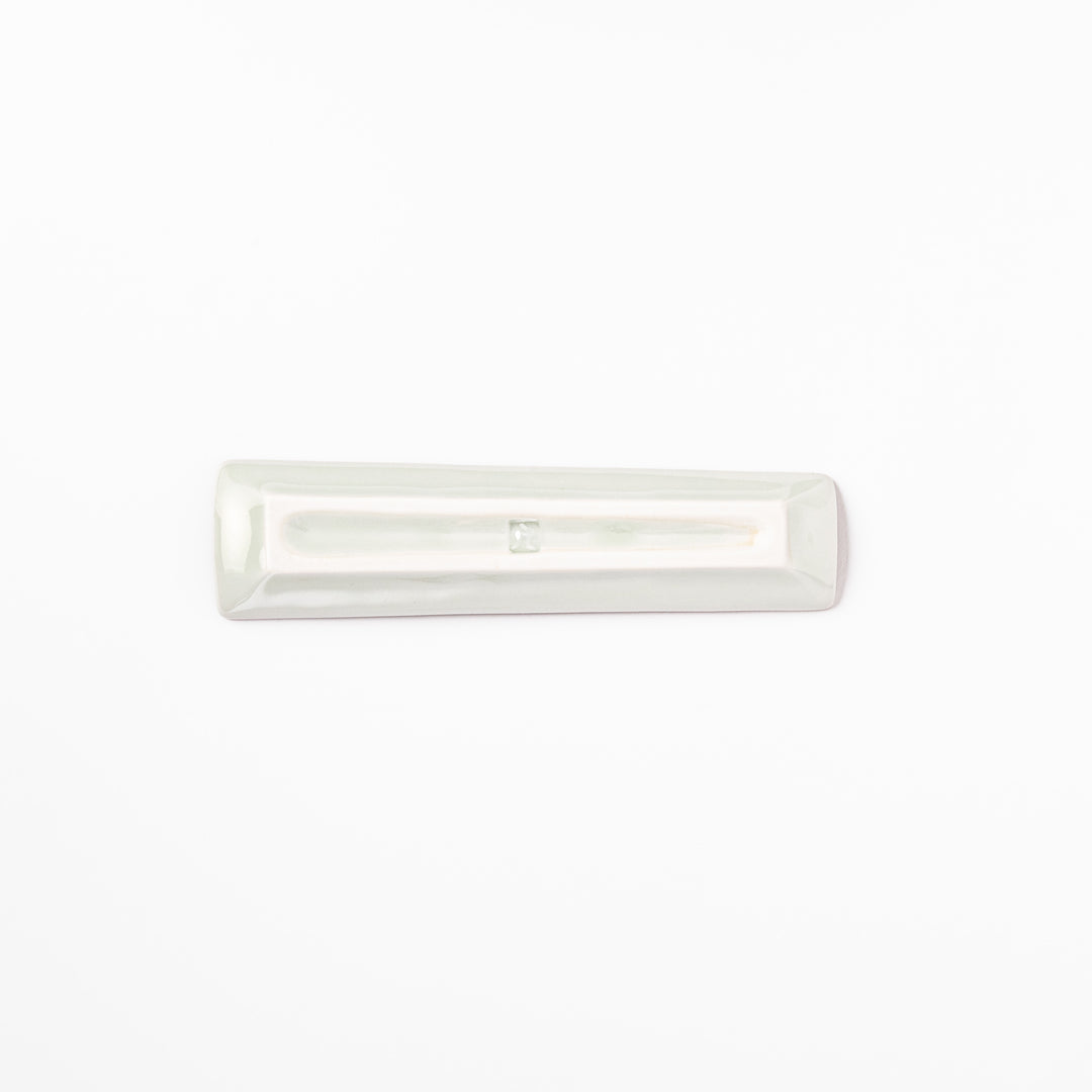 Japanese porcelain chopstick rest with whimsical Japan design featuring Mount Fuji, cherry blossoms, house, and colorful trees