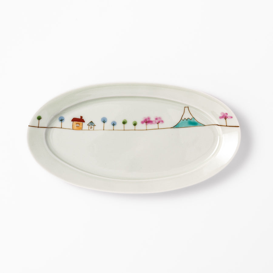 Japanese porcelain oval plate with whimsical Japan design featuring Mount Fuji, cherry blossoms, houses, and colorful trees