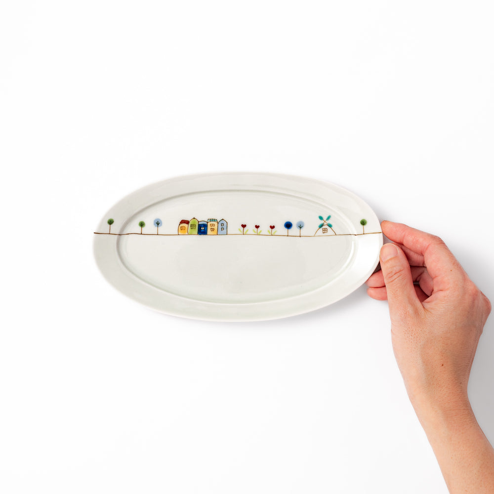 Japanese porcelain oval plate with whimsical Netherlands design featuring colorful houses, tulips, trees, and a blue windmill