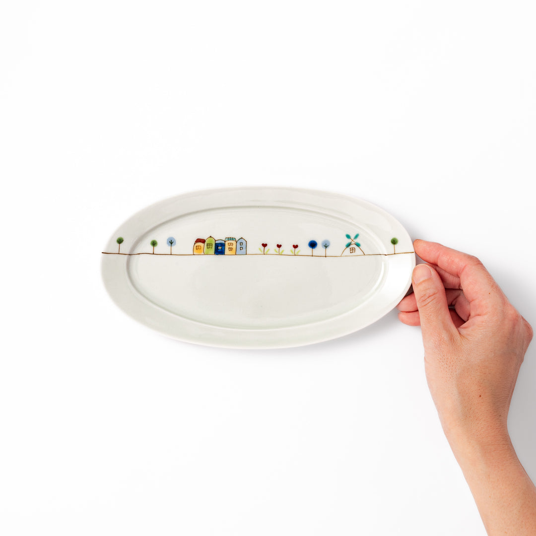 Japanese porcelain oval plate with whimsical Netherlands design featuring colorful houses, tulips, trees, and a blue windmill