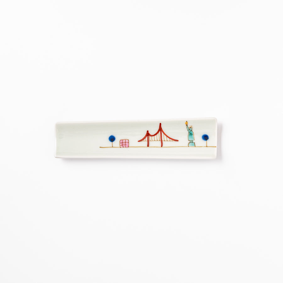 Japanese porcelain chopstick rest with USA design featuring Statue of Liberty, red bridge, and colorful cityscape accents