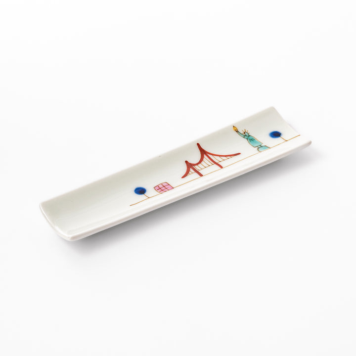 Japanese porcelain chopstick rest with USA design featuring Statue of Liberty, red bridge, and colorful cityscape accents