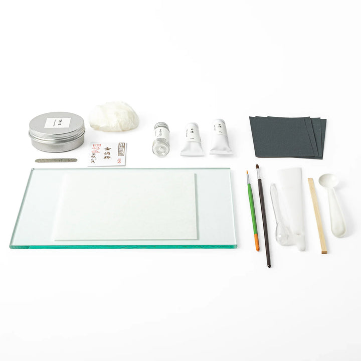 Traditional Japanese kintsugi repair starter kit, featuring authentic urushi lacquer gold powder and essential craft tools