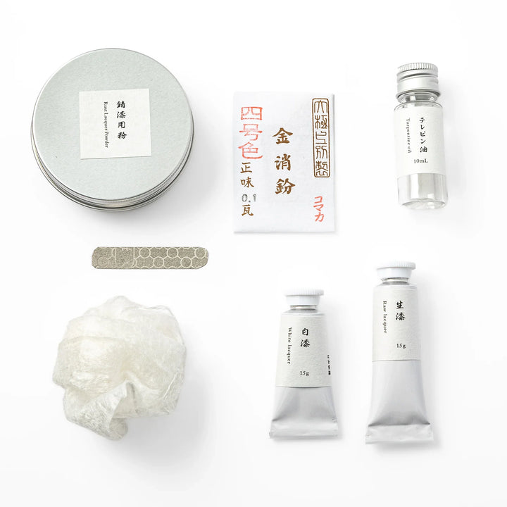 Premium materials for traditional Japanese kintsugi repair, including raw urushi lacquer tubes and fine gold powder packets