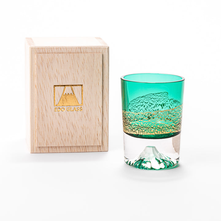 Green sake glass featuring intricate gold-leaf mountain scenery and a sculpted Mount Fuji at the base, combining elegance with Japanese artistry.