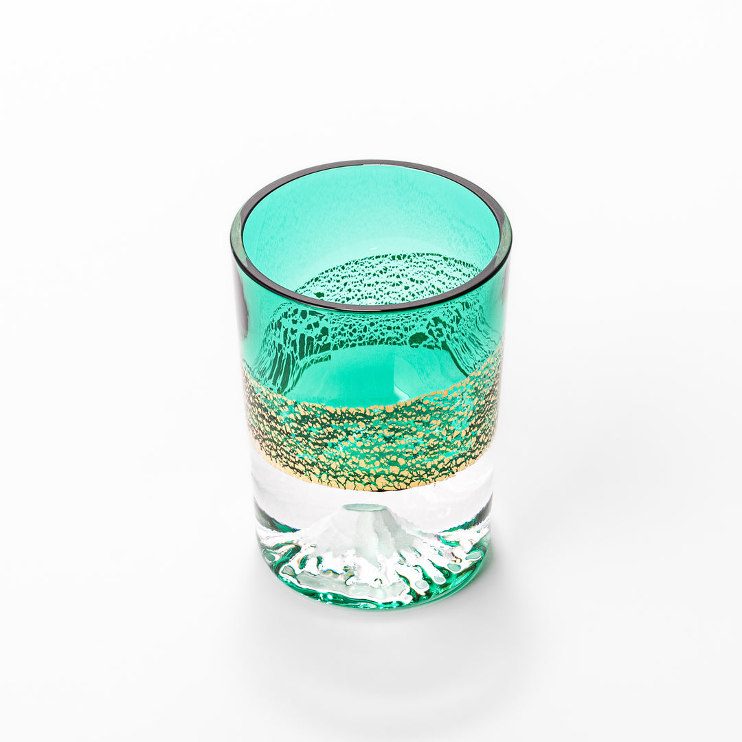Green sake glass featuring intricate gold-leaf mountain scenery and a sculpted Mount Fuji at the base, combining elegance with Japanese artistry.