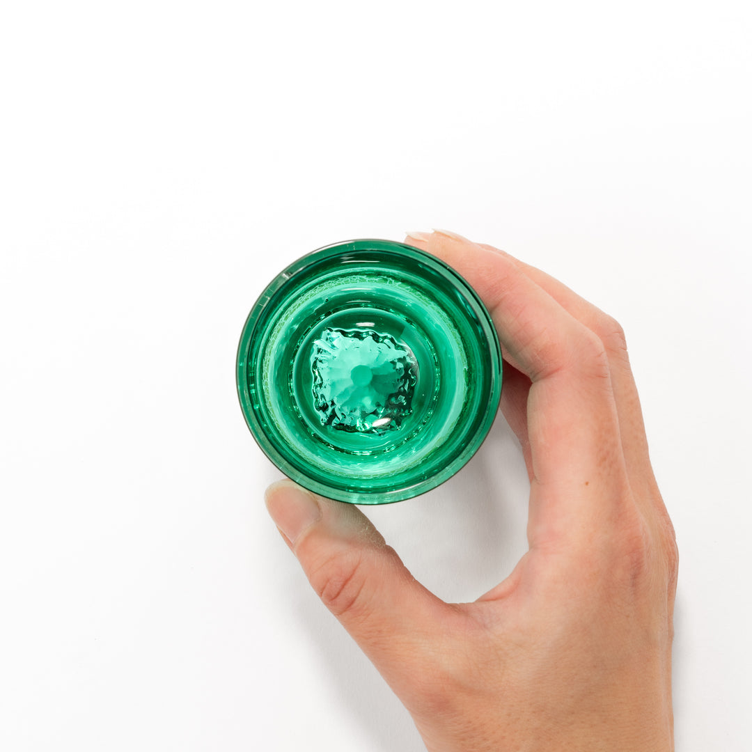 Green sake glass featuring intricate gold-leaf mountain scenery and a sculpted Mount Fuji at the base, combining elegance with Japanese artistry.