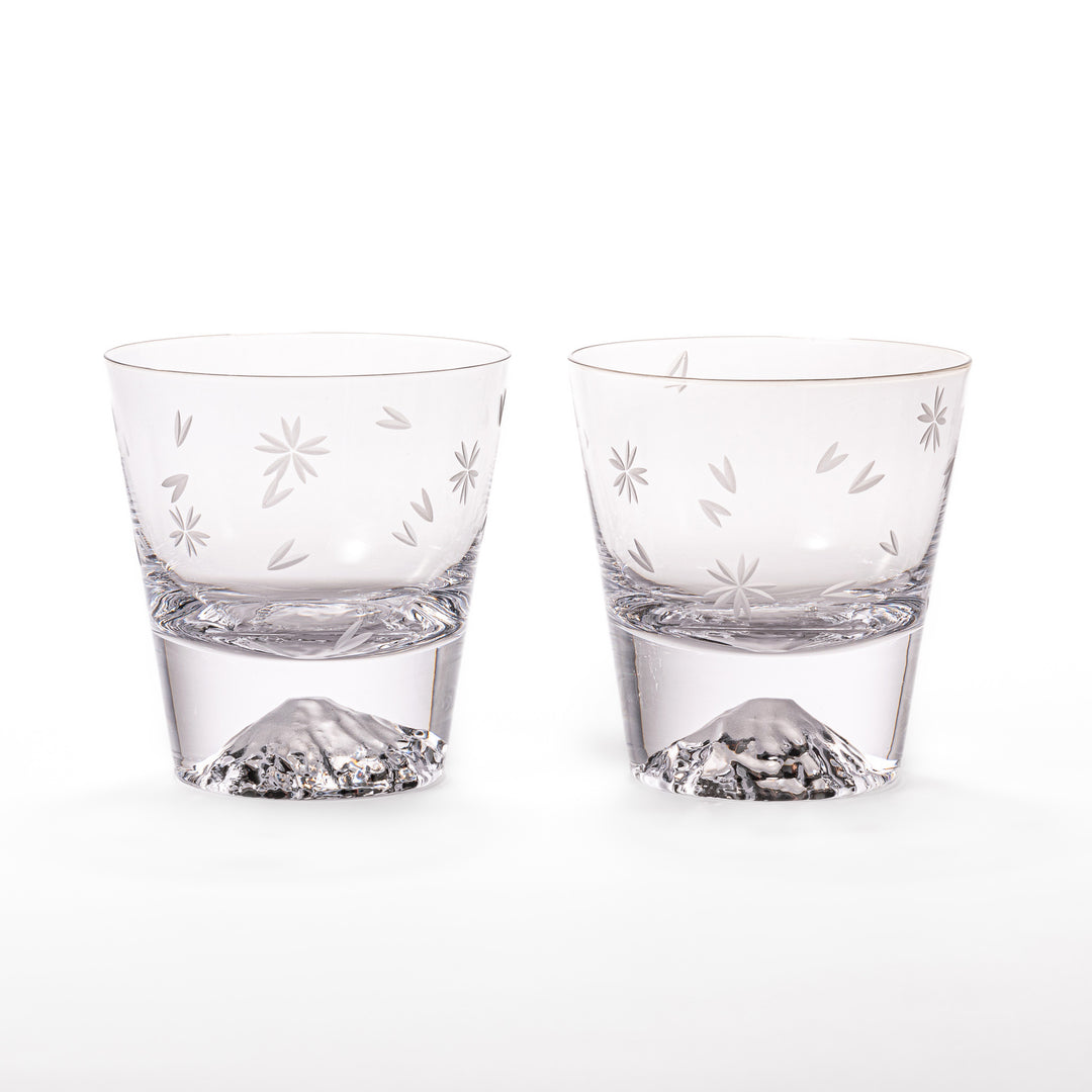 Pair of sakura-etched rocks glasses featuring a clear Mt. Fuji motif at the base, elegantly showcased for a stylish presentation.