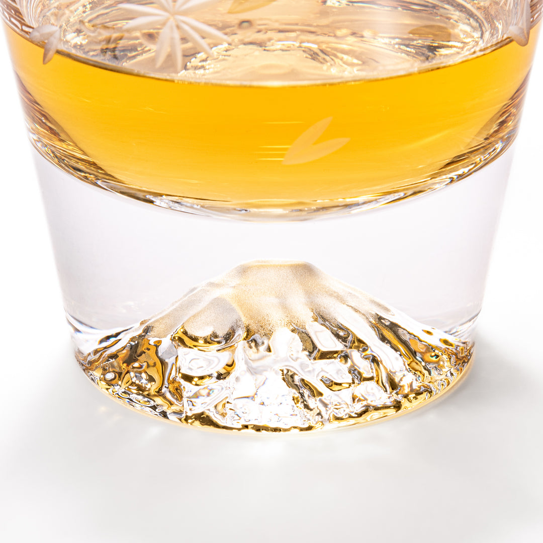 Pair of sakura-etched rocks glasses featuring a clear Mt. Fuji motif at the base, elegantly showcased for a stylish presentation.