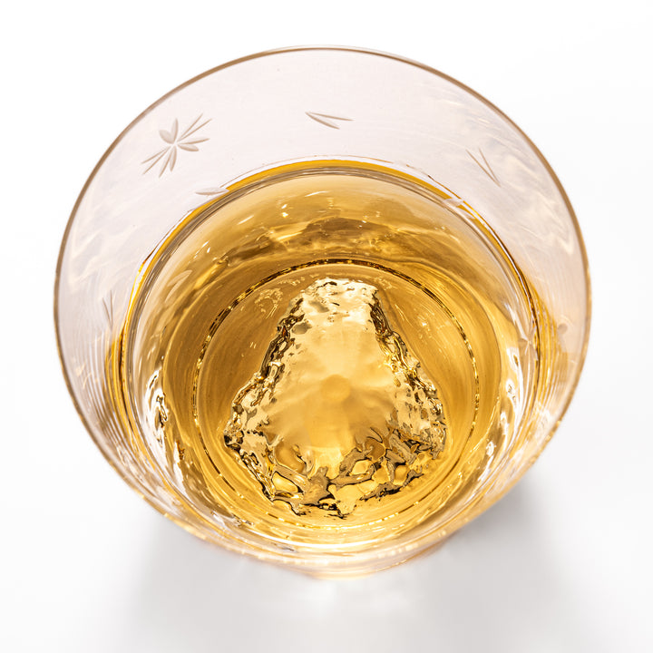 Pair of sakura-etched rocks glasses featuring a clear Mt. Fuji motif at the base, elegantly showcased for a stylish presentation.