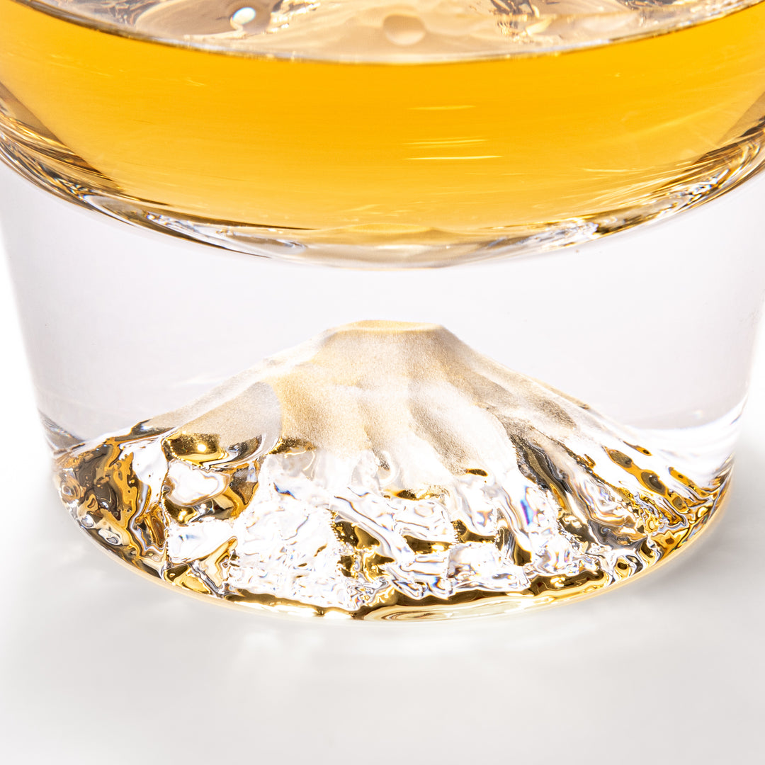 Two glasses placed inside a wooden box with the Edo Glass logo visible on the top of the box. The glasses feature a detailed design resembling Mount Fuji at the base.