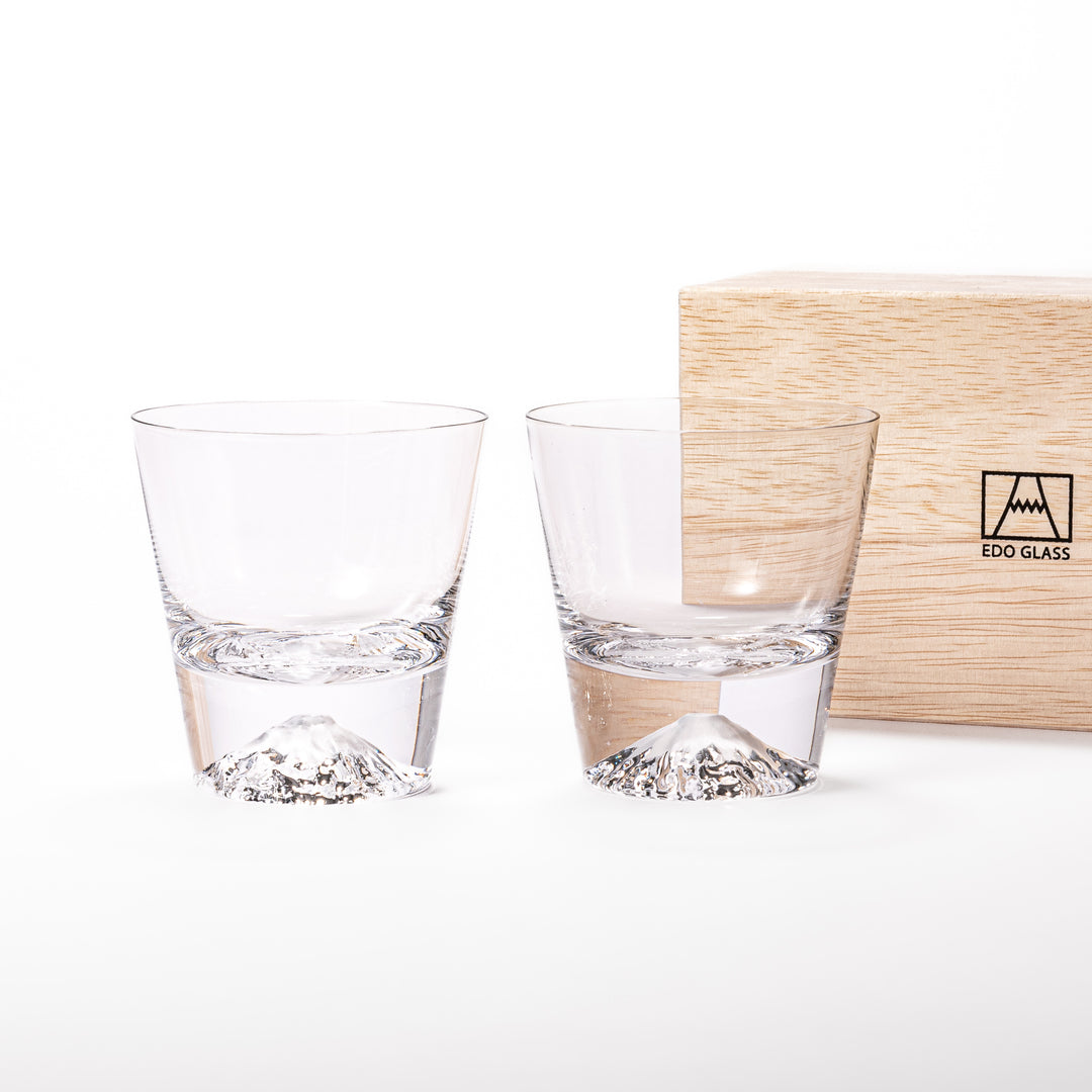 Two glasses placed inside a wooden box with the Edo Glass logo visible on the top of the box. The glasses feature a detailed design resembling Mount Fuji at the base.