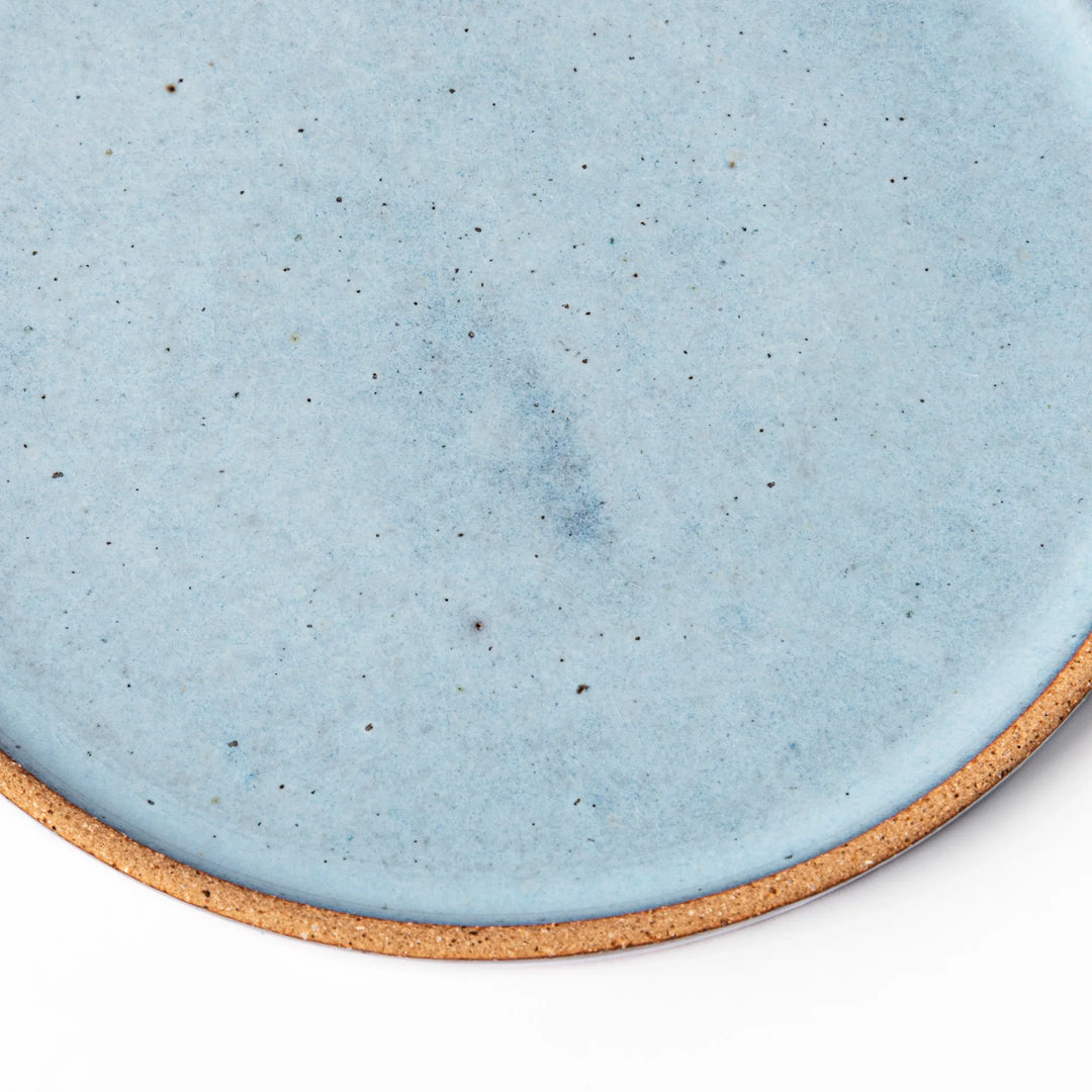 Terracotta blue ceramic dessert plate with rustic brown rim, handcrafted in Japan for serving cake, pastry, appetizers, or everyday meals.