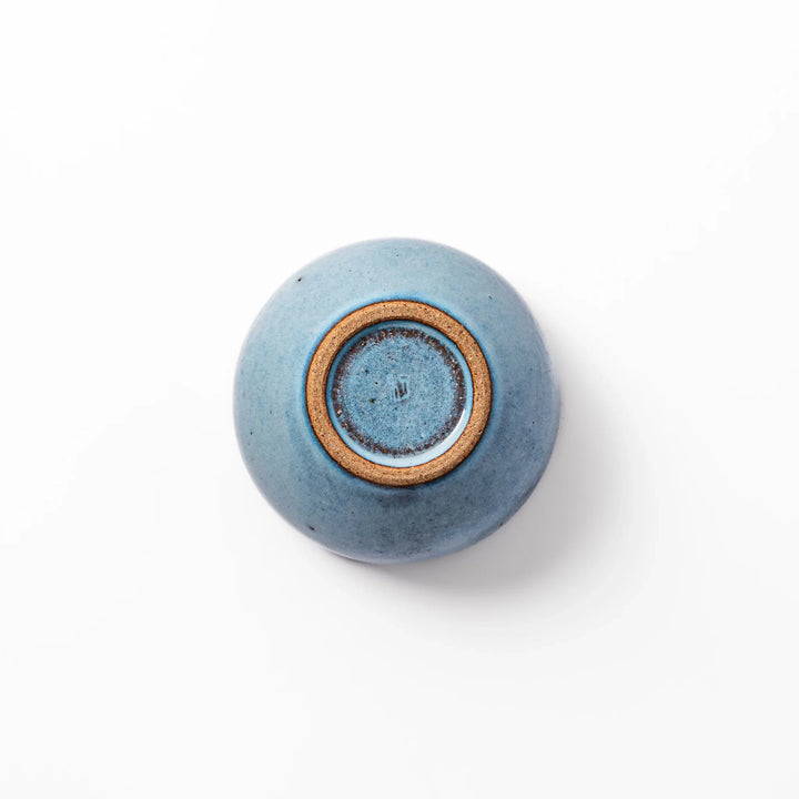 Terracotta blue ceramic tea cup with rustic brown rim, handcrafted in Japan for serving green tea, coffee, or everyday hot drinks.