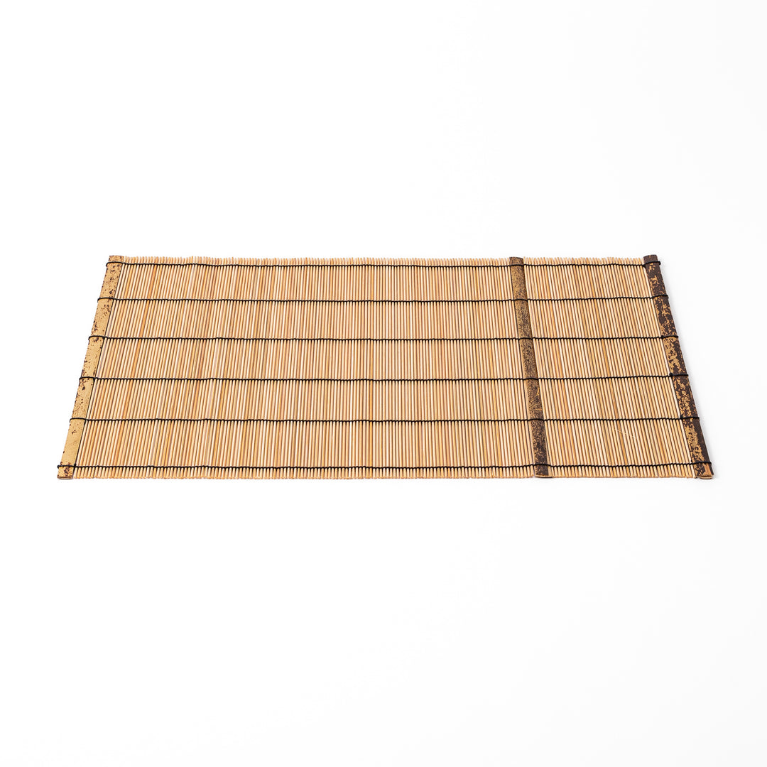 Japanese woven bamboo placemat in natural white tones with black thread accent for elegant dining table setup