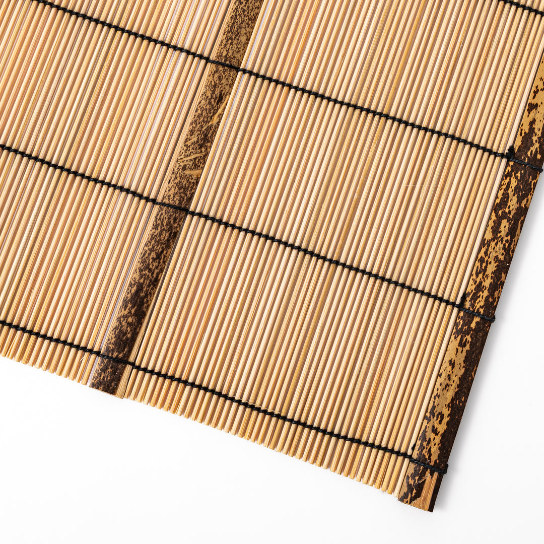 Japanese woven bamboo placemat in natural white tones with black thread accent for elegant dining table setup