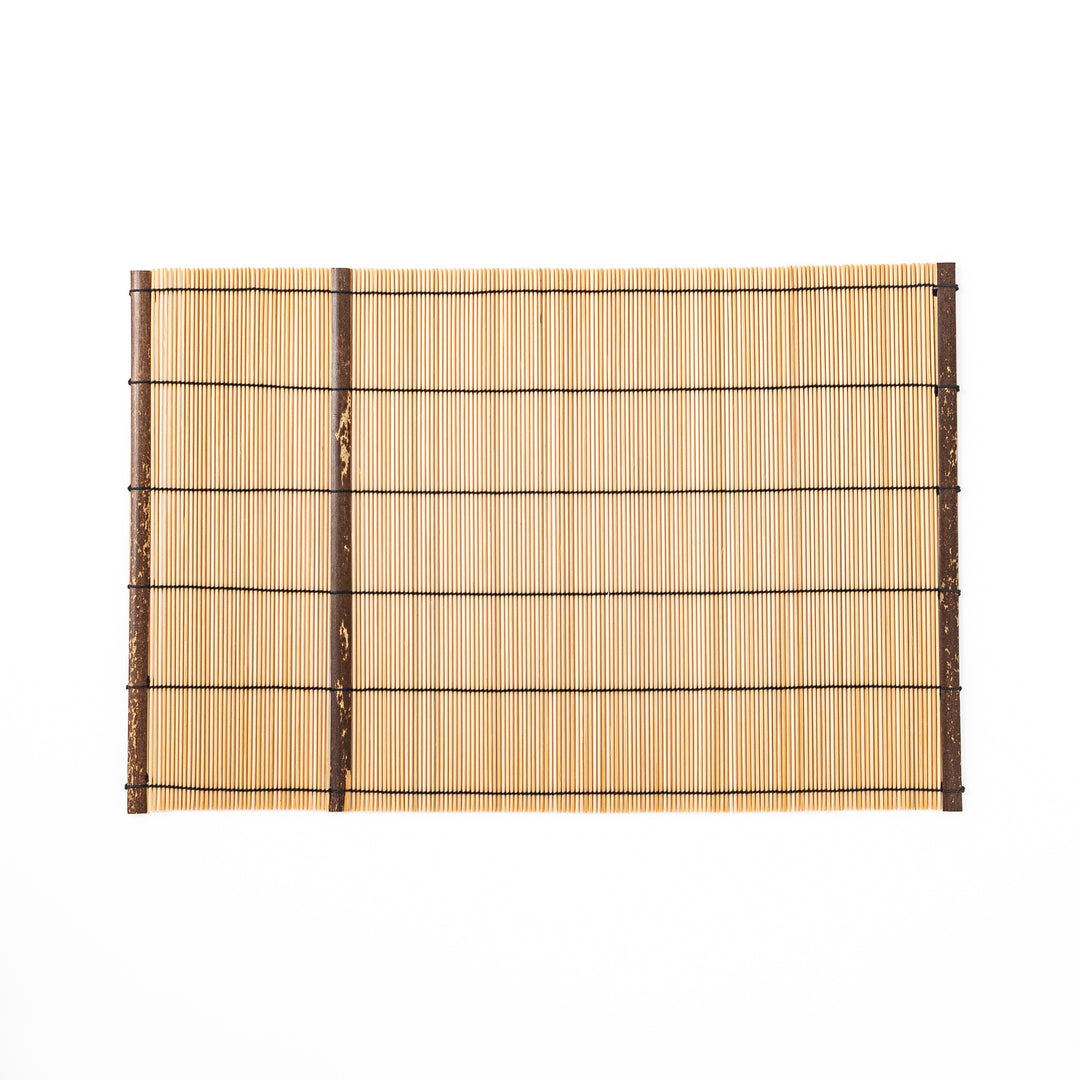 Japanese woven bamboo placemat in natural white tones with black thread accent for elegant dining table setup