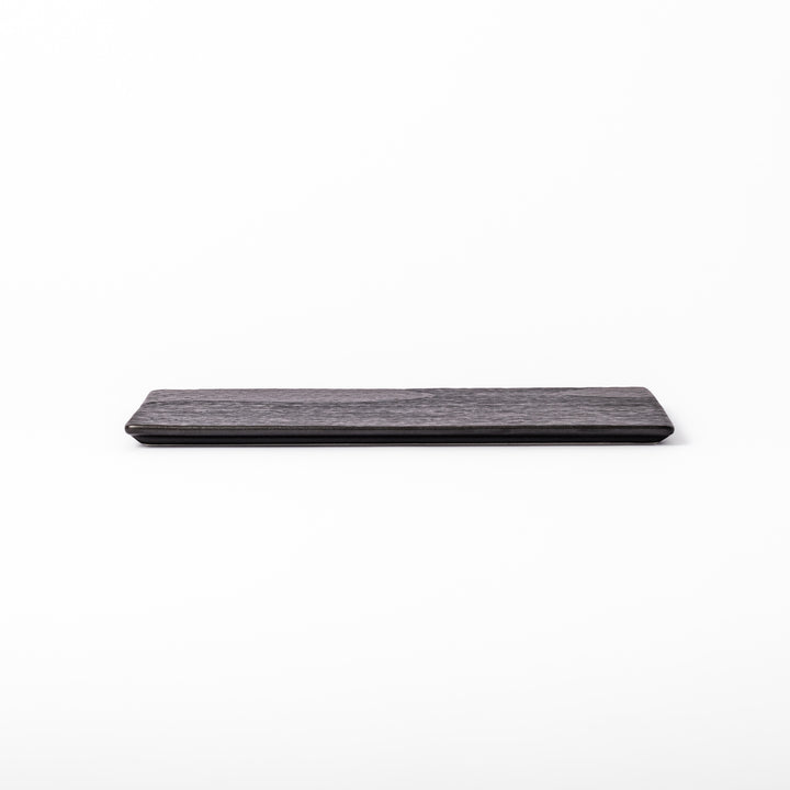 Textured black ceramic dinner plate with ridged woodgrain and matte-gloss accents, ideal for refined Japanese dining and modern presentation.