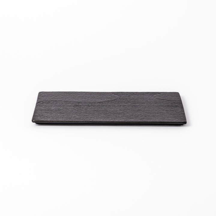 Textured black ceramic dinner plate with ridged woodgrain and matte-gloss accents, ideal for refined Japanese dining and modern presentation.