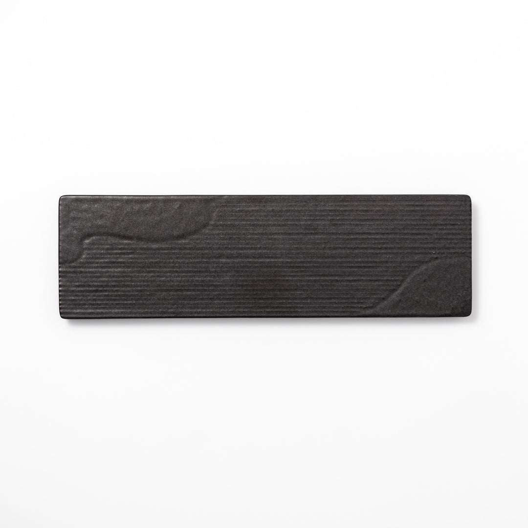 Rectangular black ceramic serving plate with a subtle ridged woodgrain texture, perfect for stylish Japanese meals and contemporary plating.