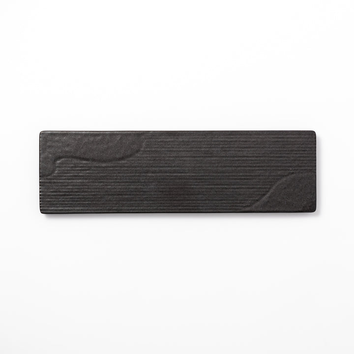 Rectangular black ceramic serving plate with a subtle ridged woodgrain texture, perfect for stylish Japanese meals and contemporary plating.