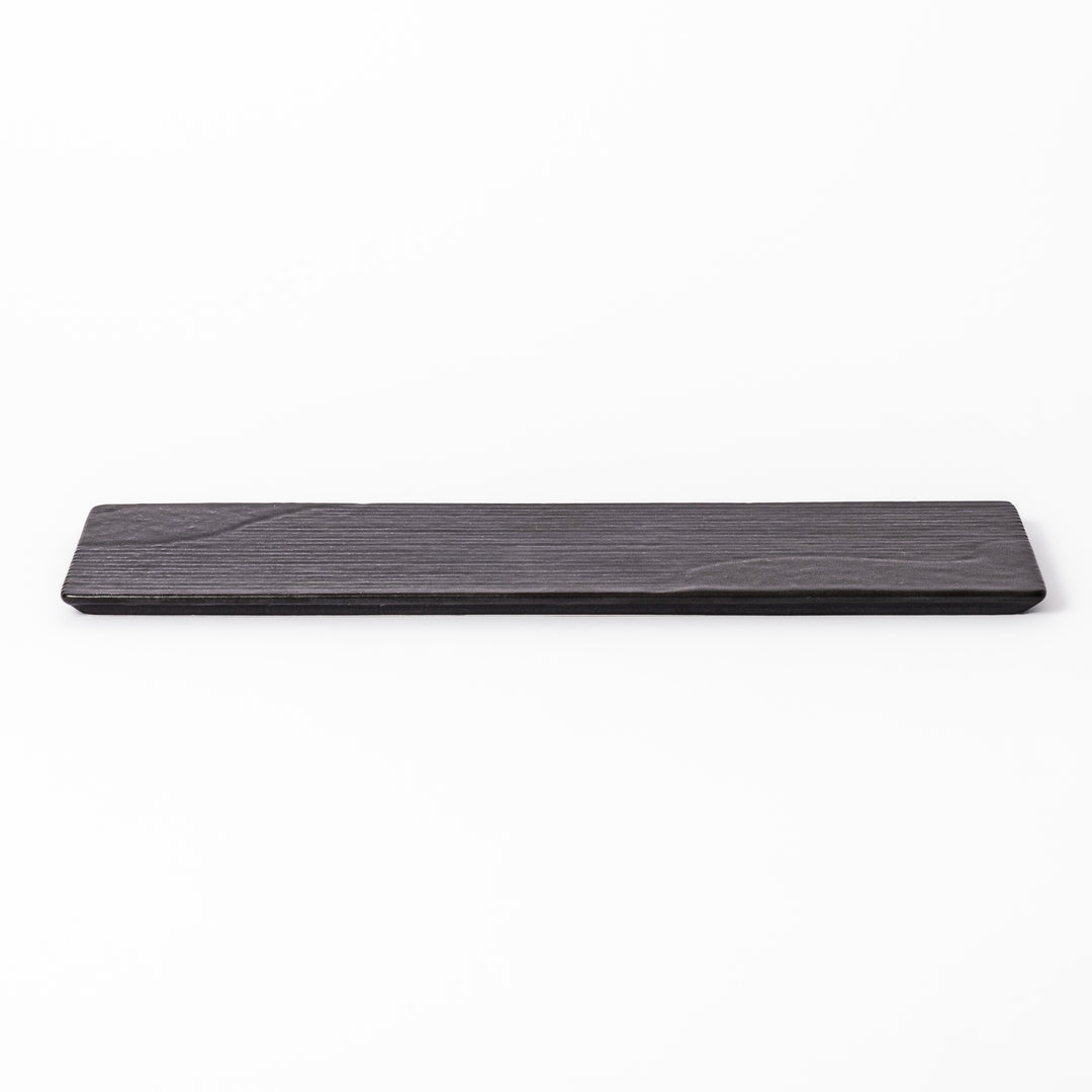 Rectangular black ceramic serving plate with a subtle ridged woodgrain texture, perfect for stylish Japanese meals and contemporary plating.