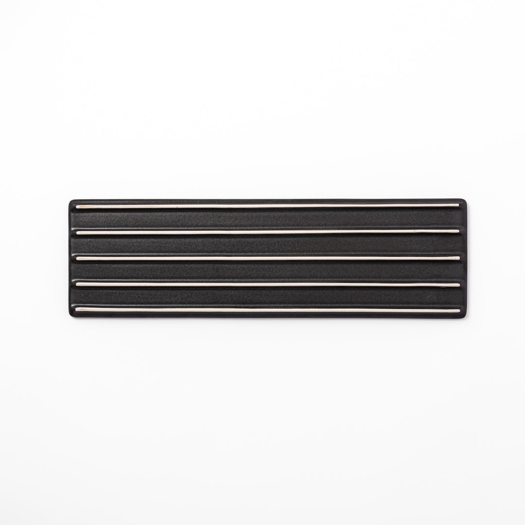 Rectangular black ceramic serving plate with a subtle ridged woodgrain texture, perfect for stylish Japanese meals and contemporary plating.