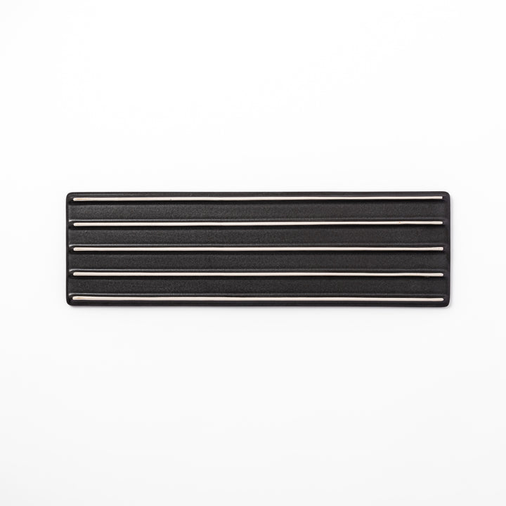 Rectangular black ceramic serving plate with a subtle ridged woodgrain texture, perfect for stylish Japanese meals and contemporary plating.