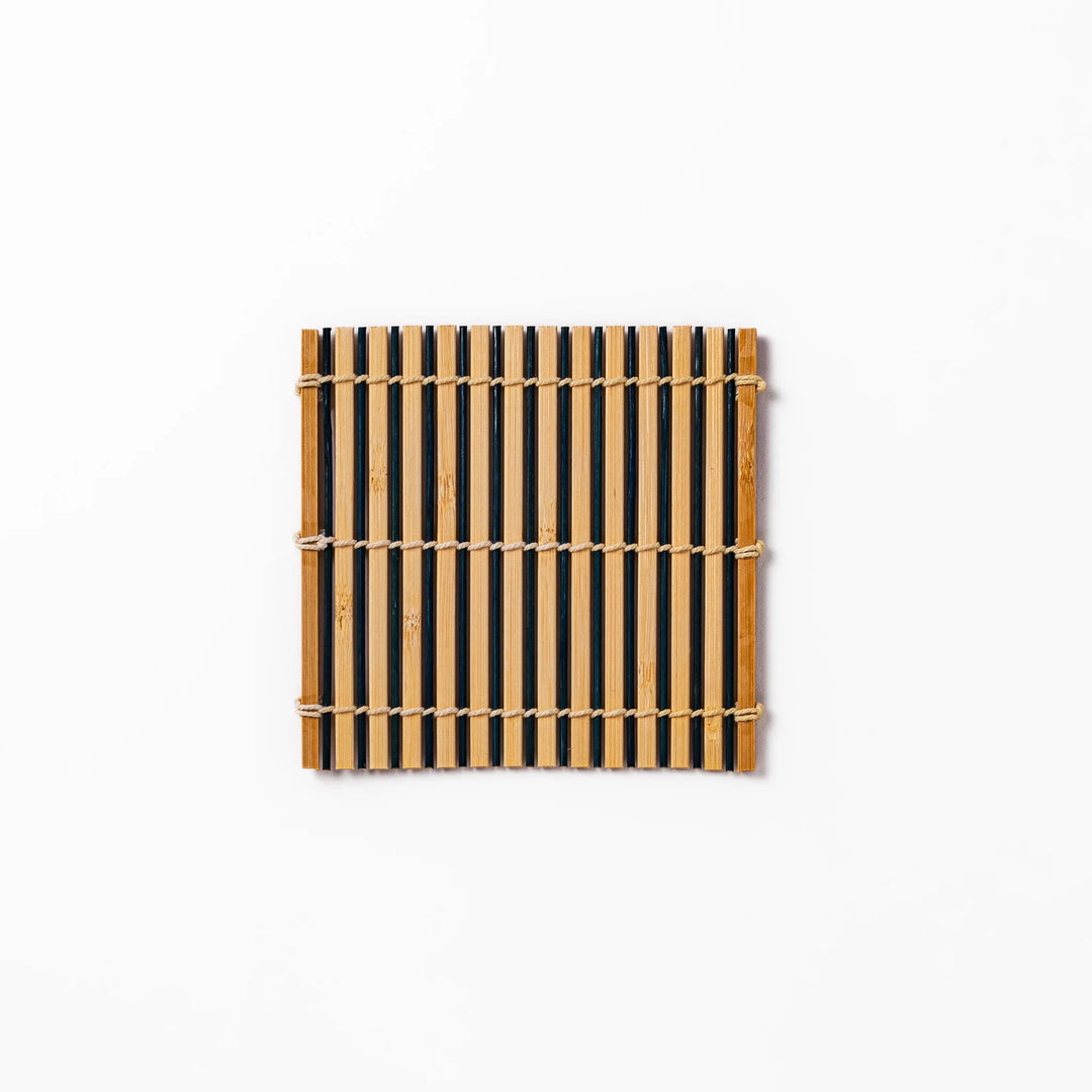 Two-tone bamboo coaster with alternating dark and natural bamboo slats, hand-tied with twine—perfect for protecting surfaces with Japanese flair.