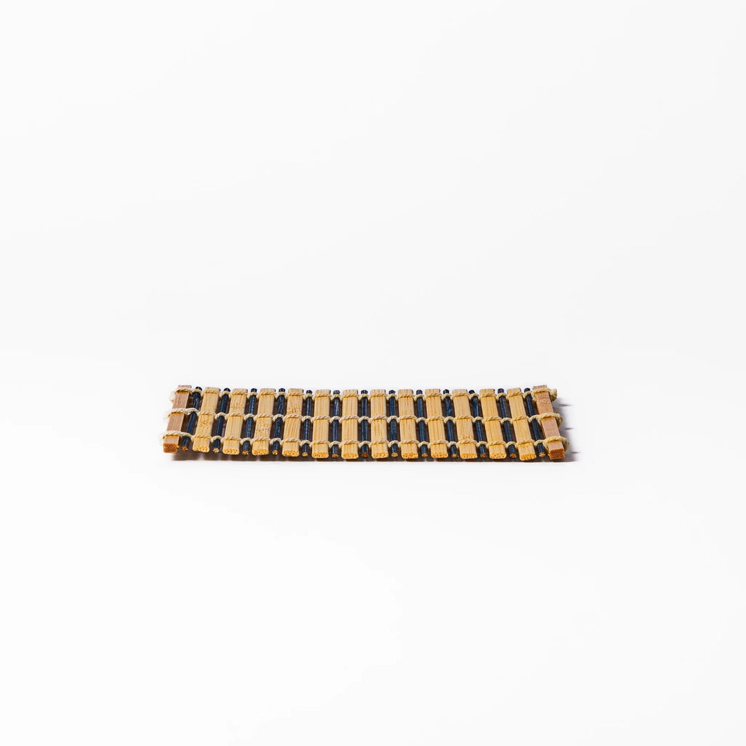 Two-tone bamboo coaster with alternating dark and natural bamboo slats, hand-tied with twine—perfect for protecting surfaces with Japanese flair.