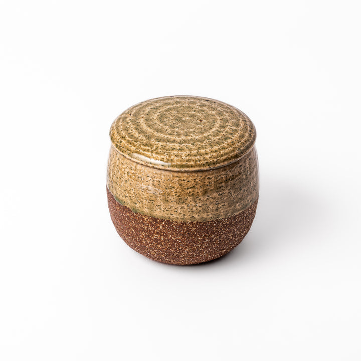 Two-tone Japanese ceramic rice storage bowl with lid, featuring smooth glazed top and textured brown lower half for rustic charm.