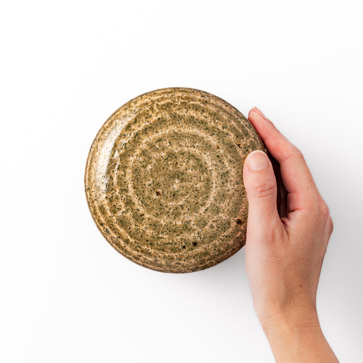 Two-tone Japanese ceramic rice storage bowl with lid, featuring smooth glazed top and textured brown lower half for rustic charm.