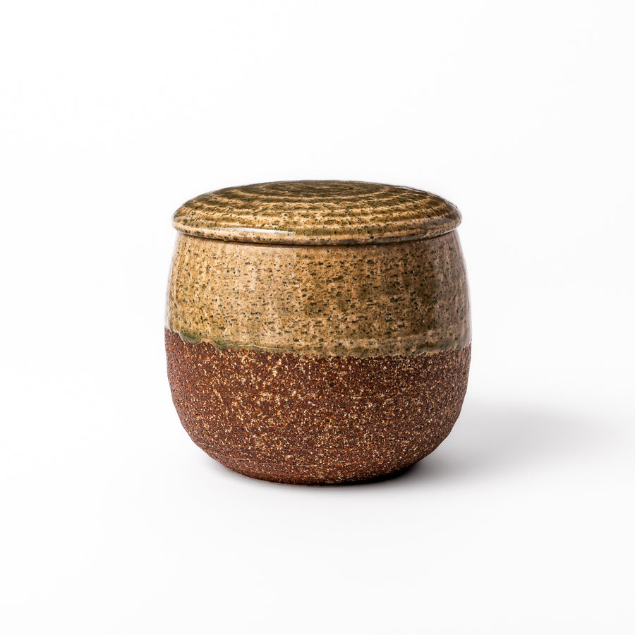 Two-tone Japanese ceramic rice storage bowl with lid, featuring smooth glazed top and textured brown lower half for rustic charm.