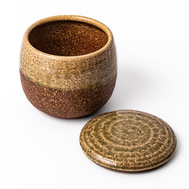 Two-tone Japanese ceramic rice storage bowl with lid, featuring smooth glazed top and textured brown lower half for rustic charm.