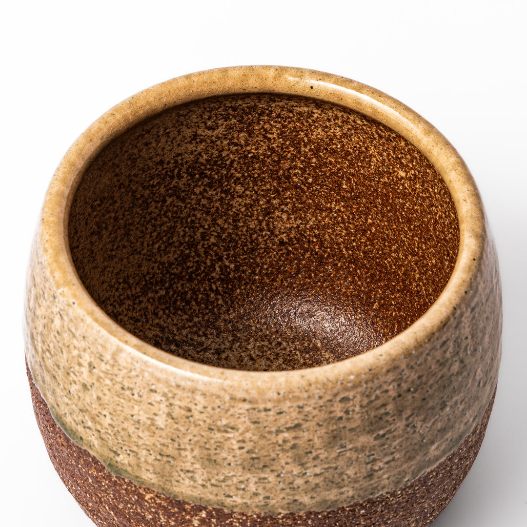 Two-tone Japanese ceramic rice storage bowl with lid, featuring smooth glazed top and textured brown lower half for rustic charm.