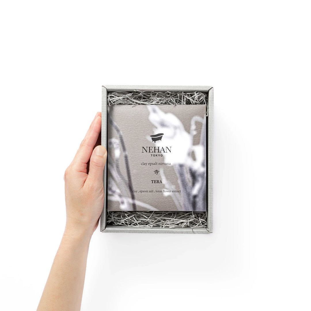 Minimalist NEHAN TOKYO gift box with a bath logo containing five assorted Epsom salt sachets on paper cushioning