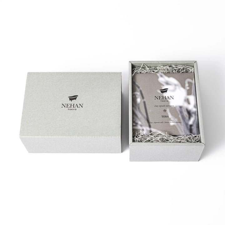 Minimalist NEHAN TOKYO gift box with a bath logo containing five assorted Epsom salt sachets on paper cushioning