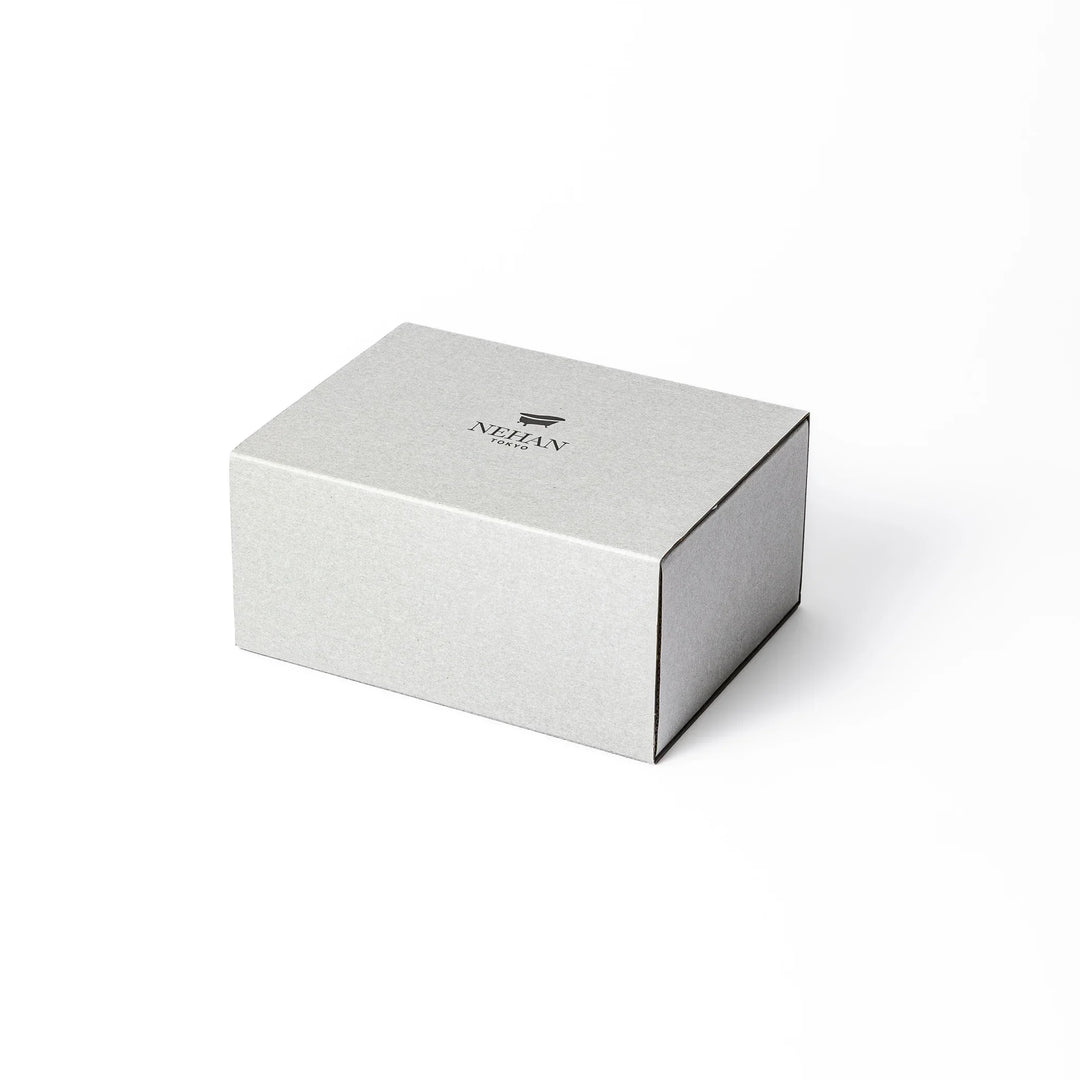 Minimalist NEHAN TOKYO gift box with a bath logo containing five assorted Epsom salt sachets on paper cushioning