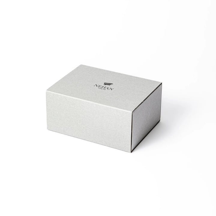Minimalist NEHAN TOKYO gift box with a bath logo containing five assorted Epsom salt sachets on paper cushioning