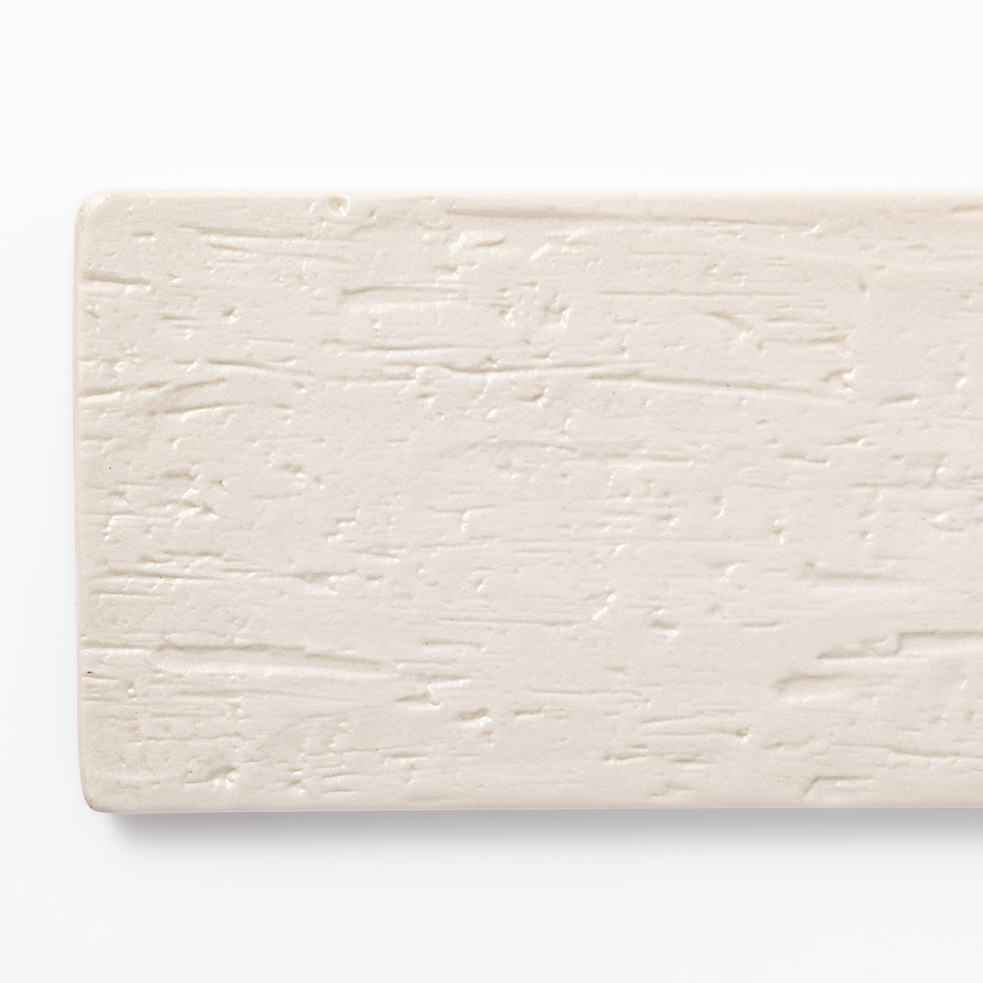 Textured rectangular white ceramic serving plate with a woodgrain-like pattern, perfect for minimalist Japanese table settings or modern kitchens.