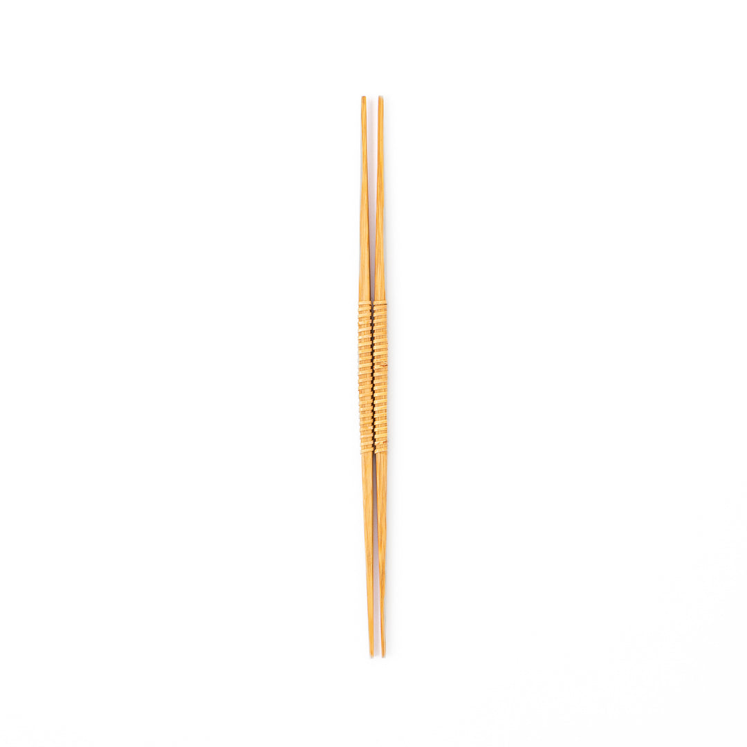 A pair of Japanese bamboo serving chopsticks featuring fine tapered tips on both ends and a textured wrapped center grip