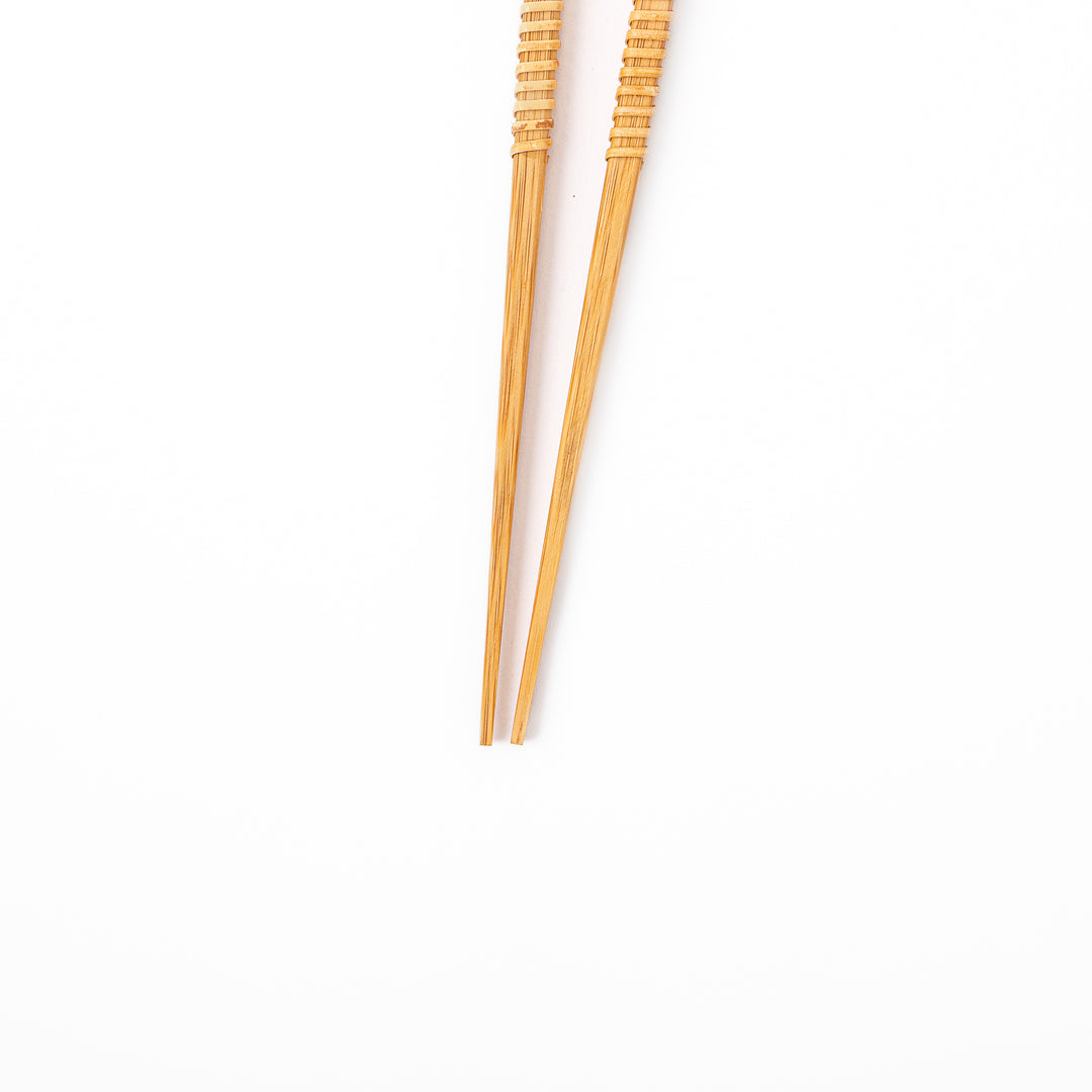 A pair of Japanese bamboo serving chopsticks featuring fine tapered tips on both ends and a textured wrapped center grip